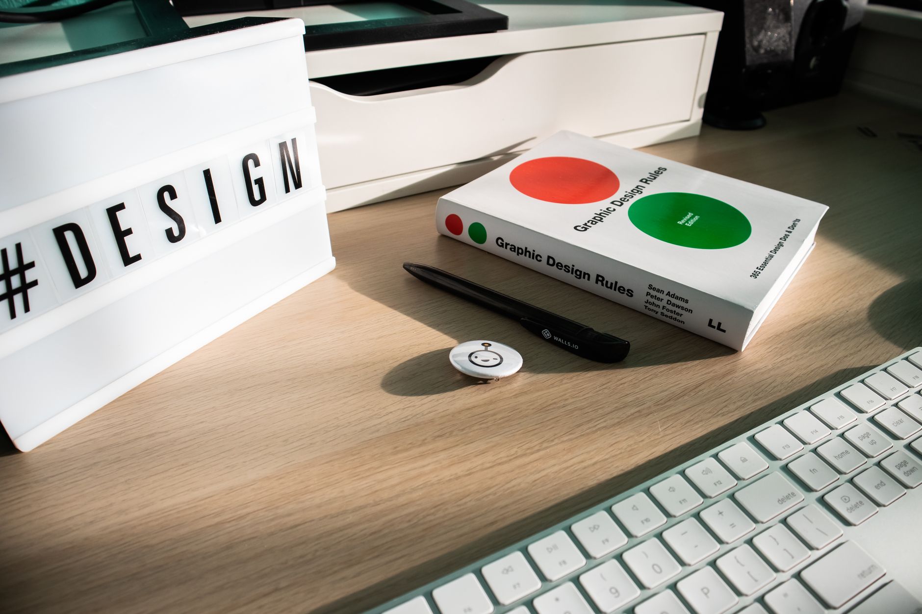 An open brand guidelines book showing a colour palette and typography pages