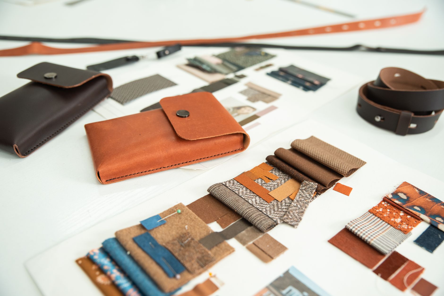 Fabric swatches, wood samples and paint chips arranged on a studio table for an apartment living room