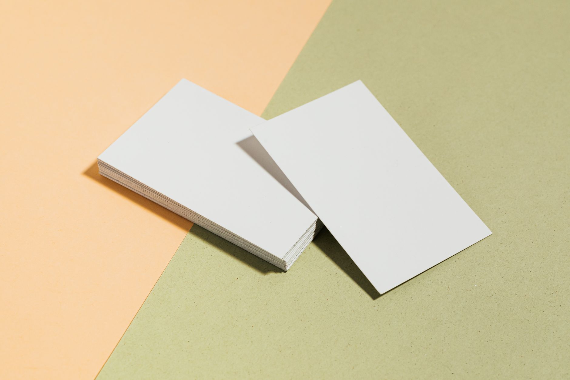 A white card massing model of a house on a cutting mat