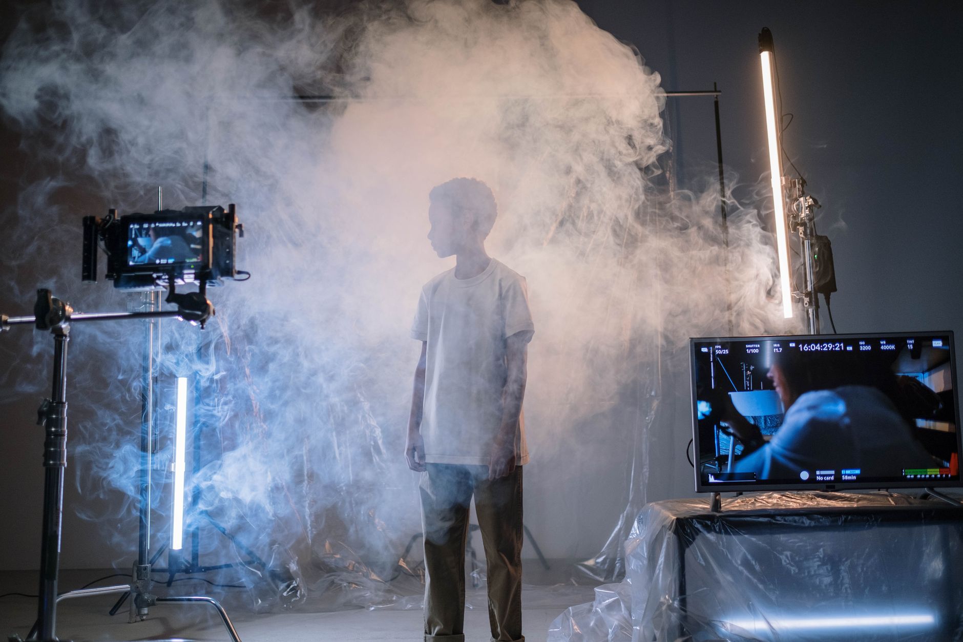 A film set with a large LED wall showing a digital landscape behind the crew