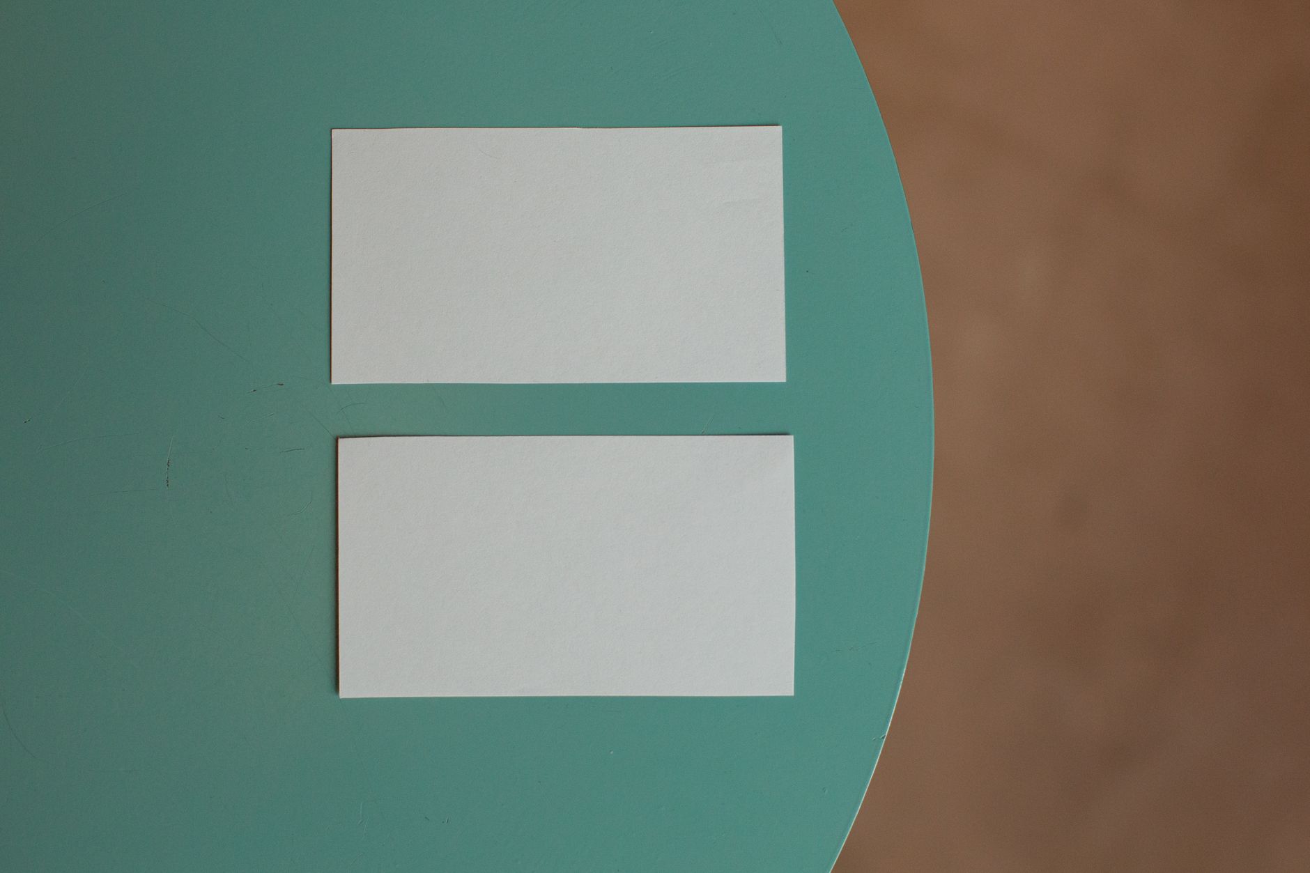 Printed brand identity mockups and stationery laid out on a studio table