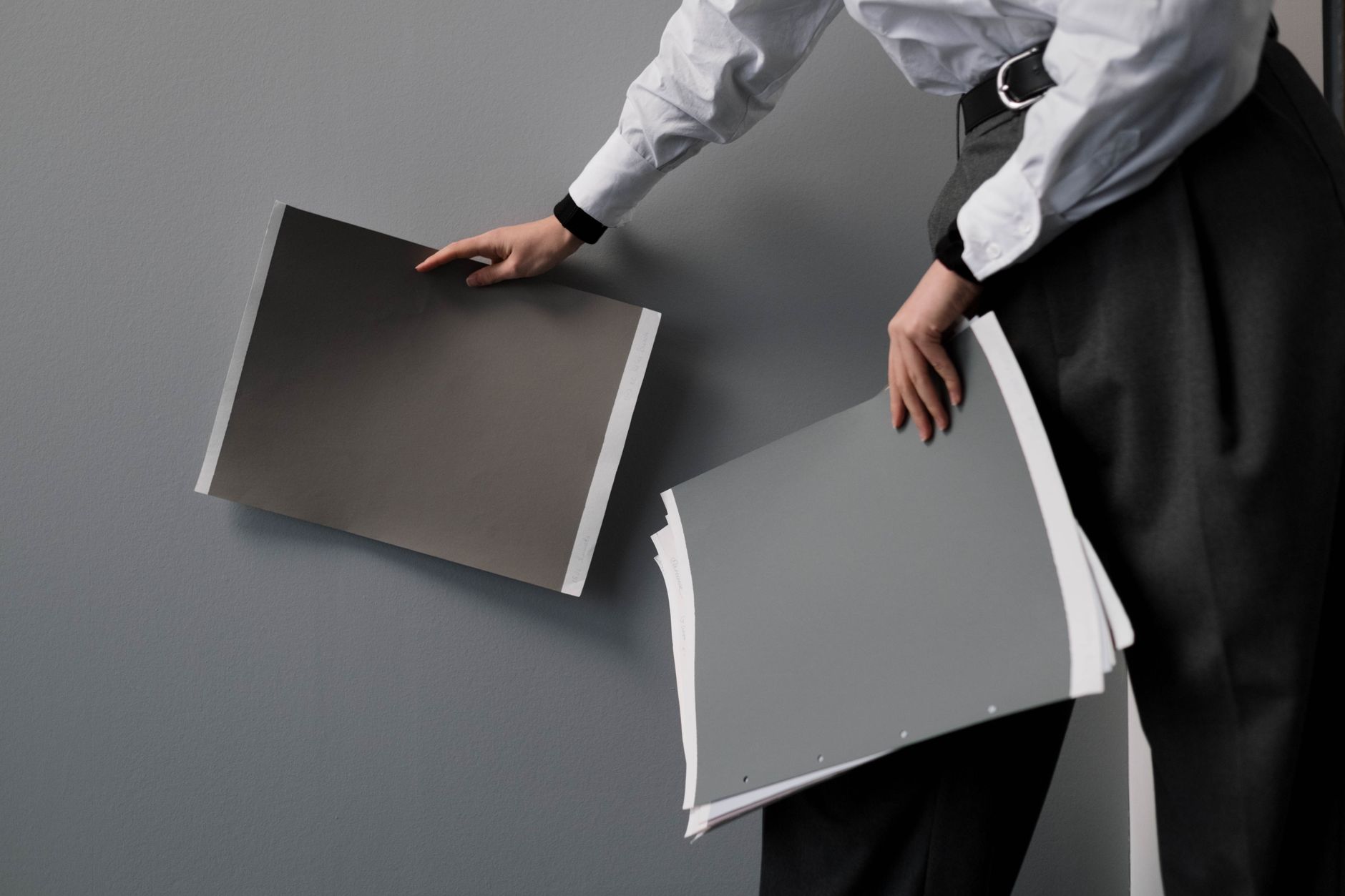 Printed presentation boards pinned to a studio wall