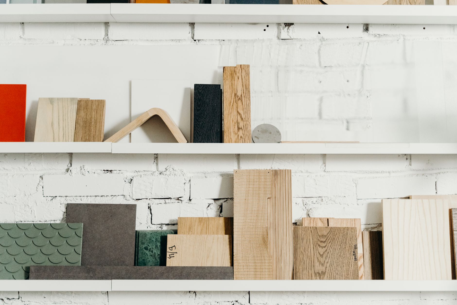Brick, timber and stone samples laid out on a studio table