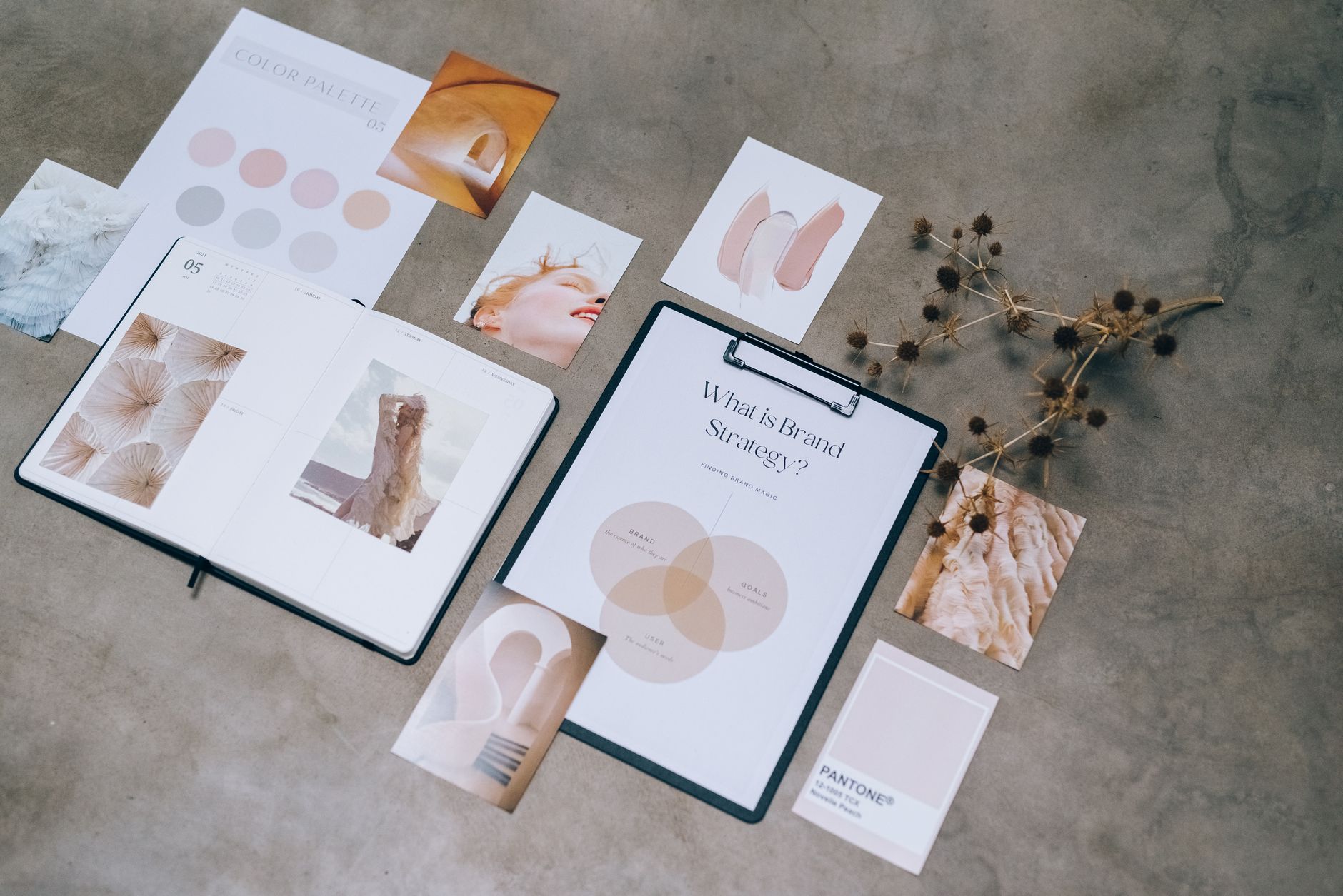 A moodboard with colour swatches, type specimens and photo references pinned to a studio wall