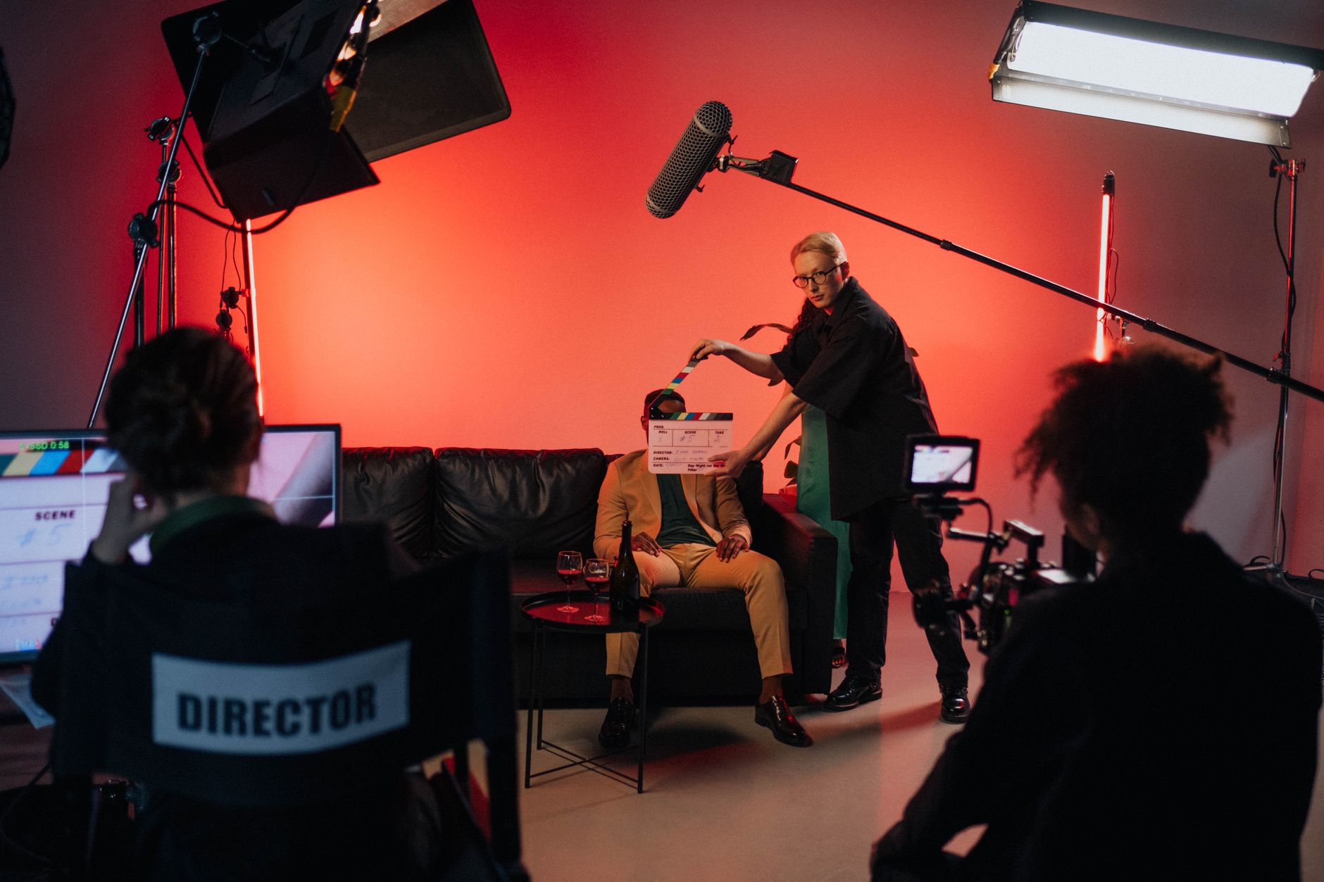 Film lights, a camera on a dolly and cables on a studio floor during a shoot