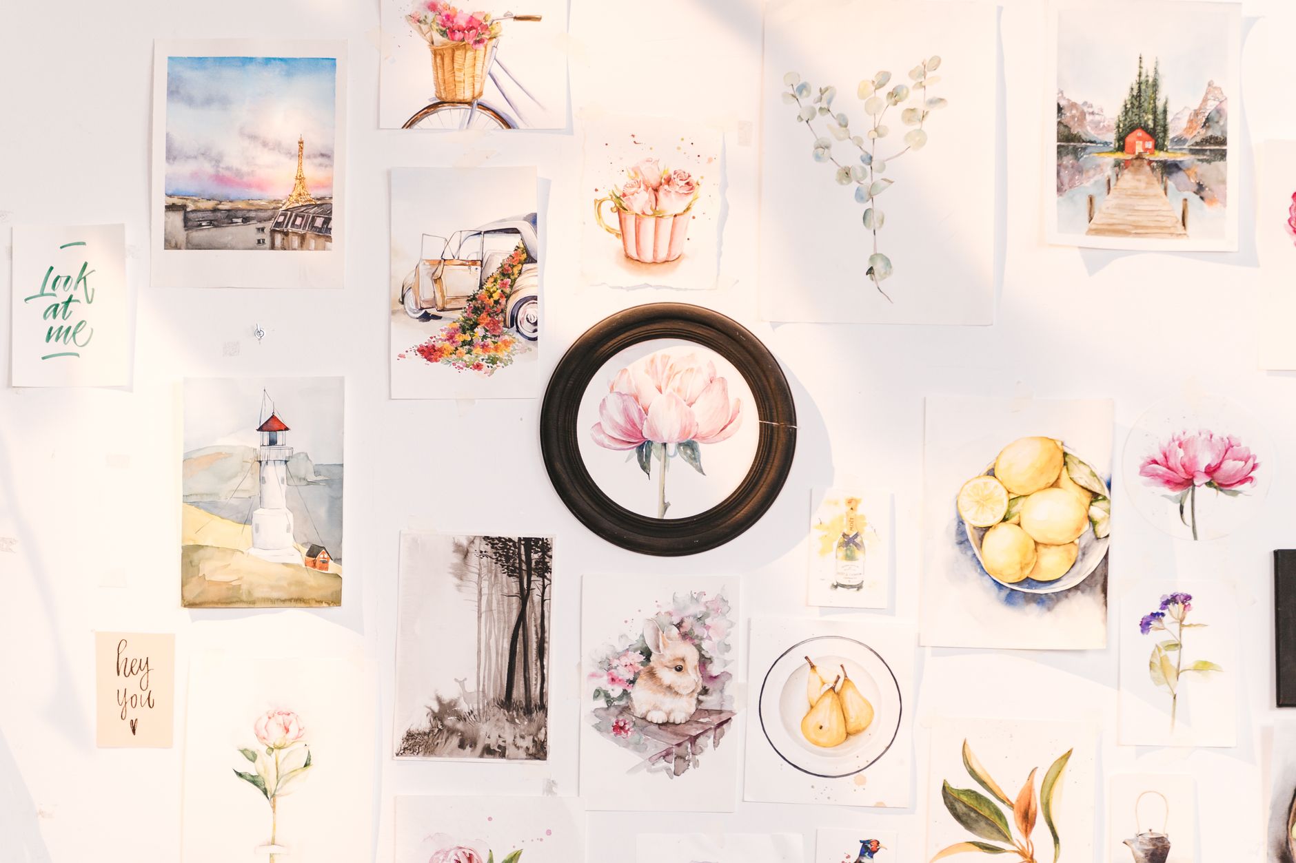 Large printed design pieces pinned to a studio wall