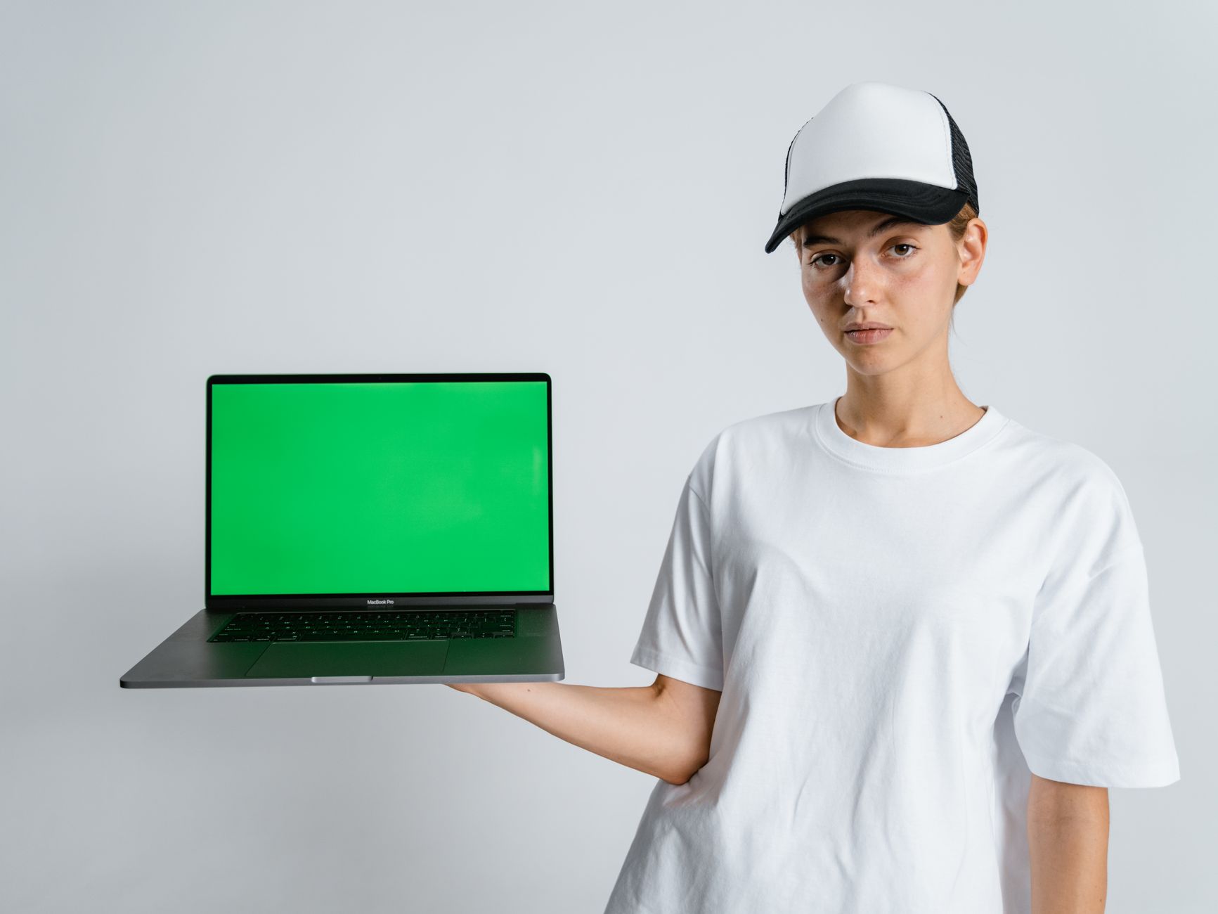 A laptop on a desk showing a brand identity presentation