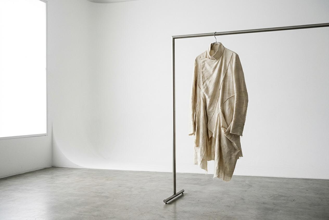 Silk garment on a rail in a white studio
