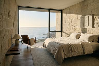 Guest room with sandstone walls facing the ocean