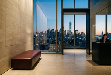 Reception with limestone, oxblood leather and blackened steel at dusk