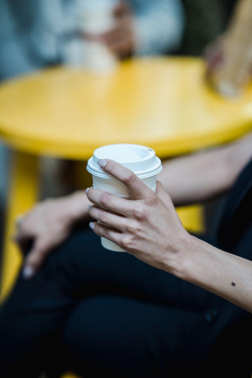 Hands around a coffee cup