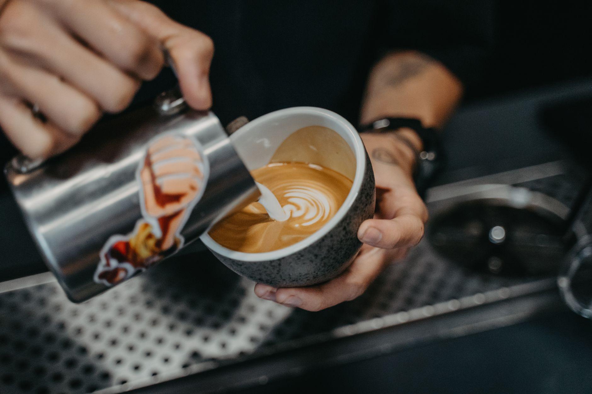 Barista pouring latte art